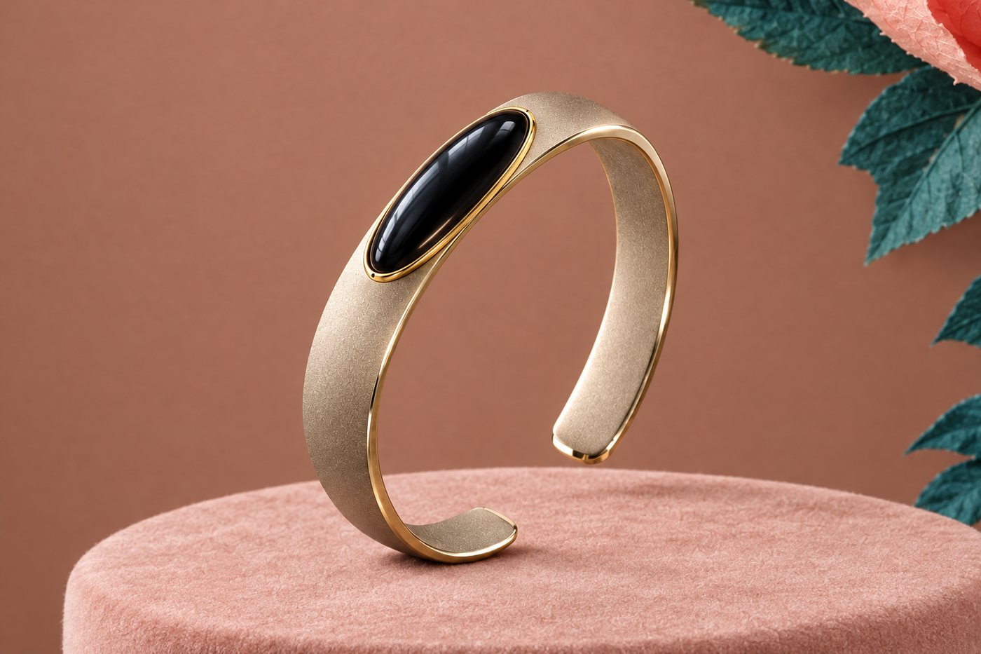 Render of the titanium cuff with the long oval black stone in a gold-tone titanium rim