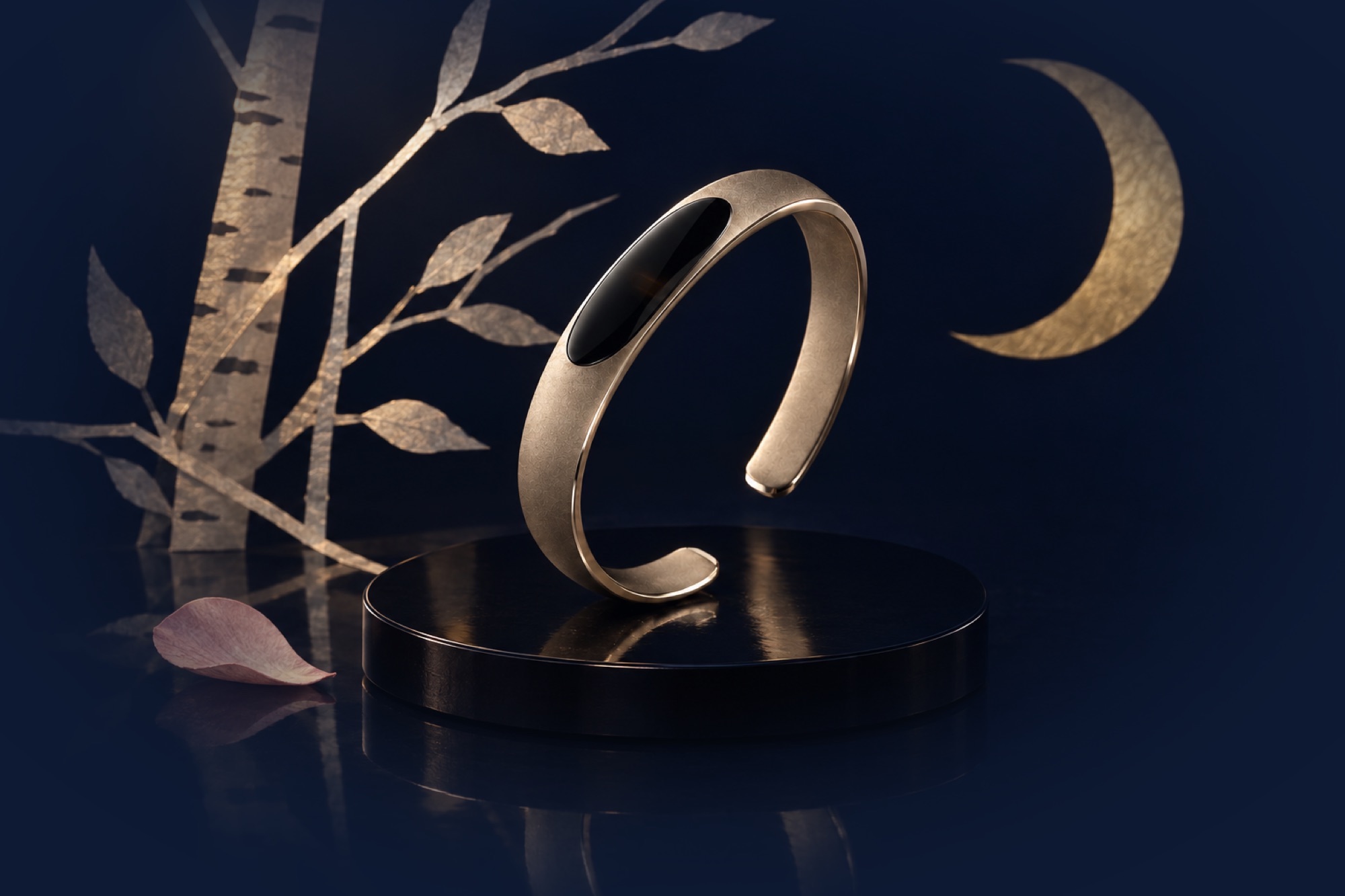Le Pinson on a black lacquer disc at night, between paper birch branches under a gold paper moon. Press and hold the stone to hear the song